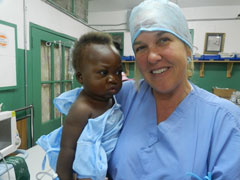 Dr. Carter Humanitarian Work holding a baby